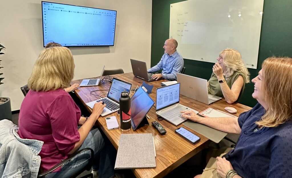 Team discussing how to assist an outsourced accounting client.